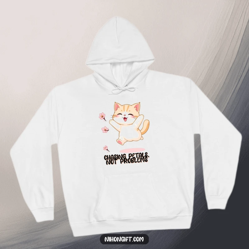 Funny hoodie illustration of a fluffy cat joyfully leaping towards a falling cherry blossom petal, capturing a moment of playful delight.