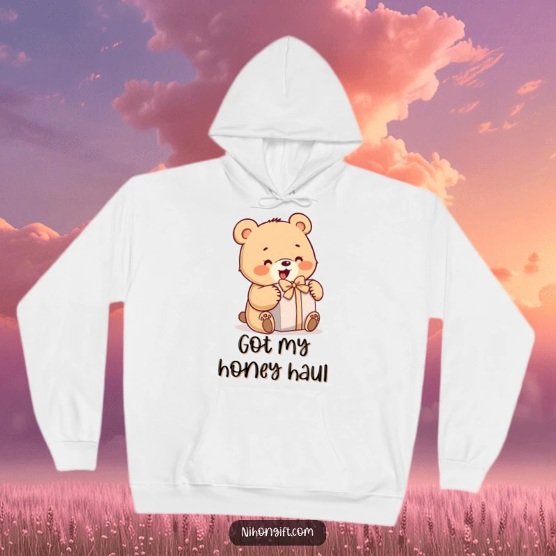 Funny bear hoodie depicting a little bear enthusiastically opening a wrapped gift, perfect for staying warm with humor.