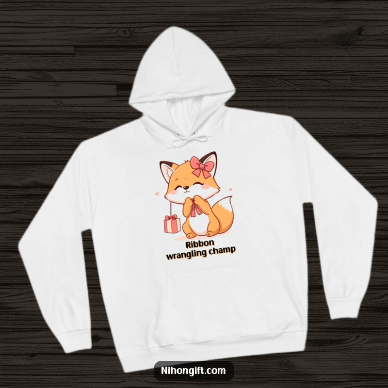 Funny Kawaii Fox Hoodie showcasing a cute fox playfully batting at a dangling gift ribbon, offering warmth and whimsical charm.