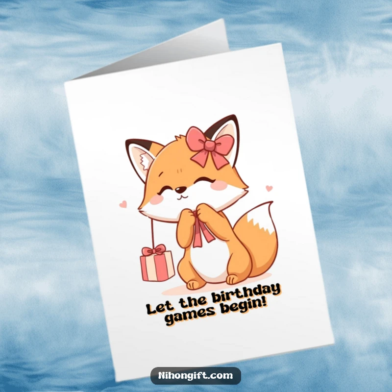 Funny free printable birthday card: A cute kawaii fox playfully batting at a dangling shiny gift ribbon, ready for birthday celebrations.