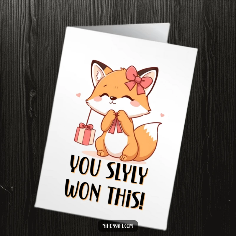 Funny free printable congratulations card: Kawaii fox joyfully batting at a dangling gift ribbon, celebrating your special news.