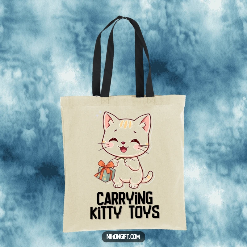 Funny cat tote bag featuring a smiling character happily dangling a string from a gift, adding charm.